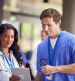 two-medical-staff-in-white-coats-and-scrubs-with-d-2023-11-27-05-10-31-utc_result.webp